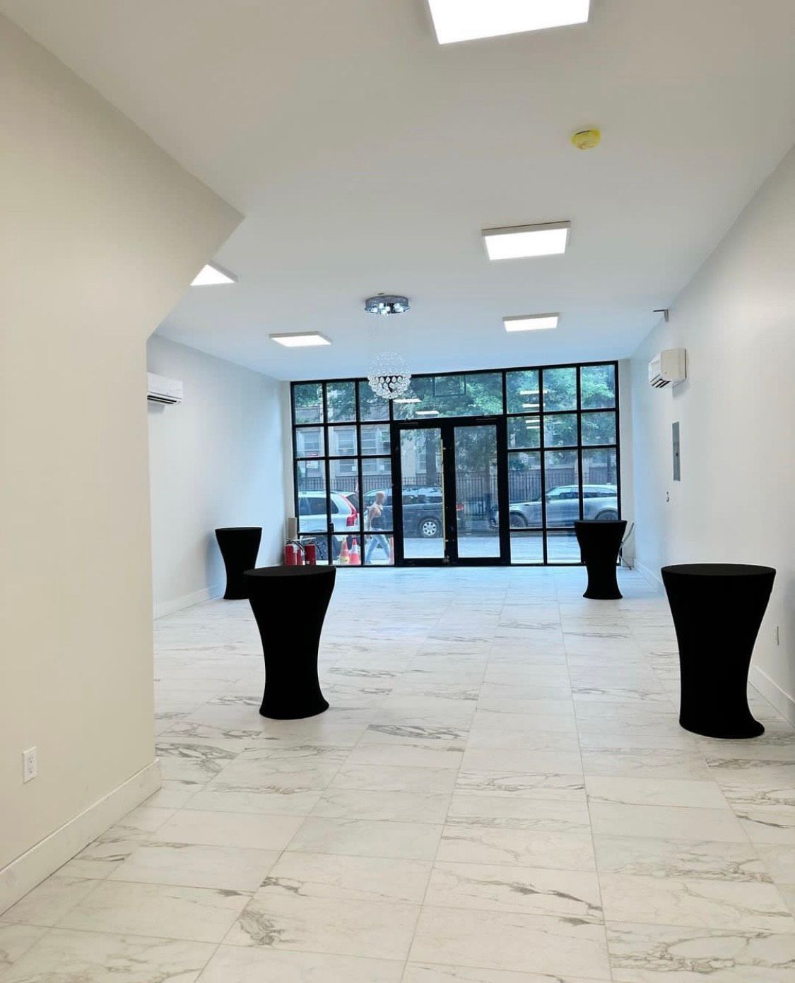 Elegant hotel lobby with chandeliers, seating areas, and columns.