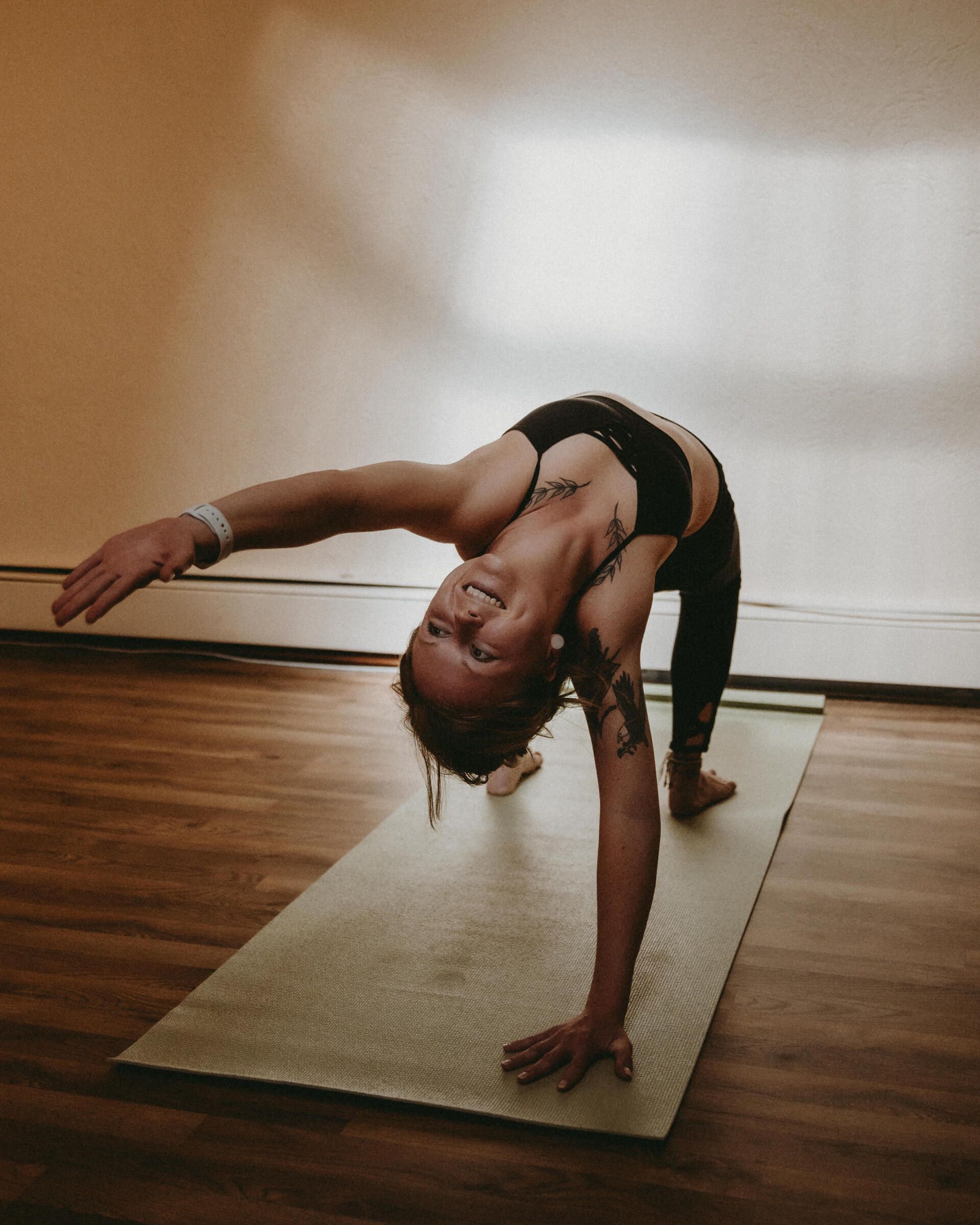 A woman is doing a yoga pose on a mat.