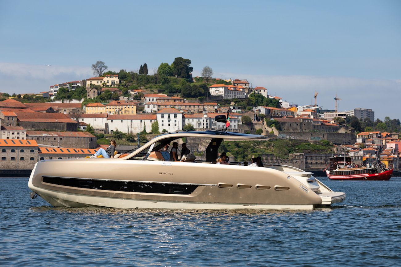 Um barco flutua sobre um corpo d'água com uma cidade ao fundo.