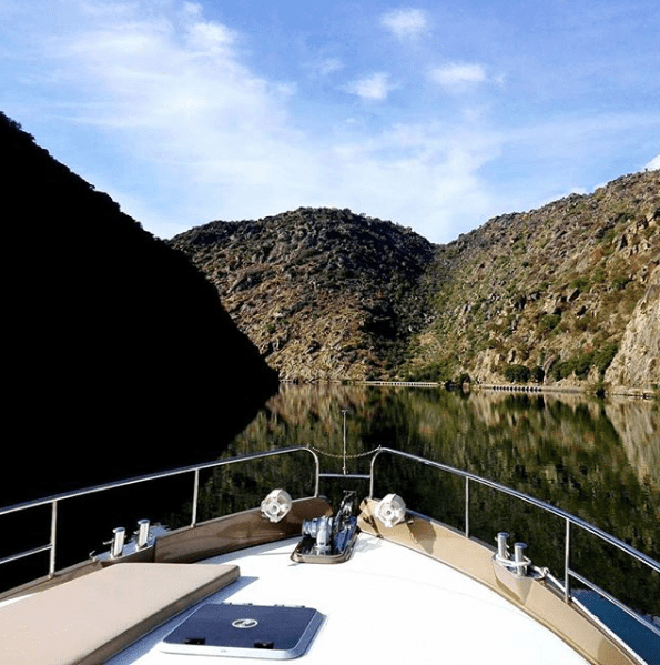 A boat on a lake with mountains in the background