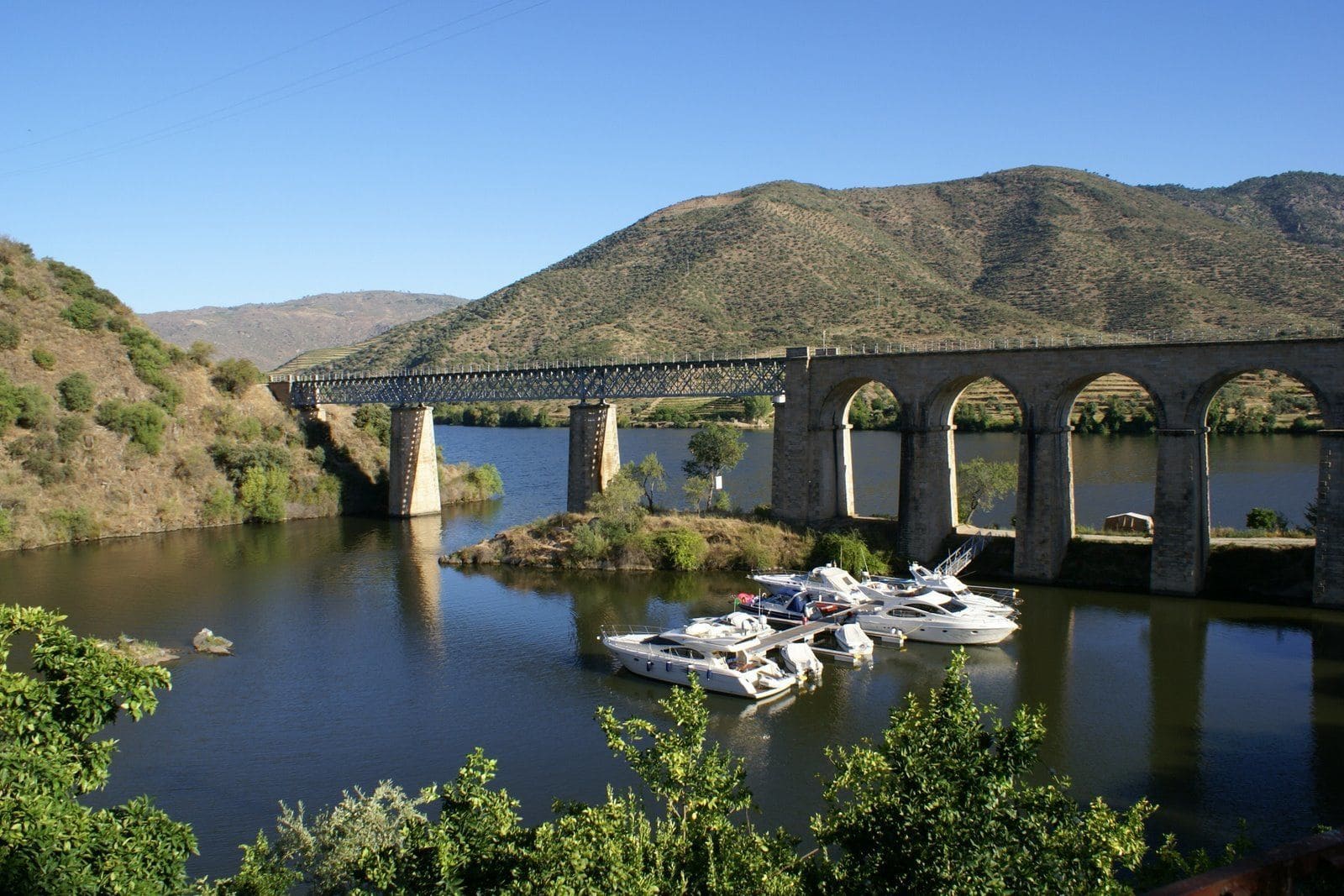 A bridge over a lake with boats in the water