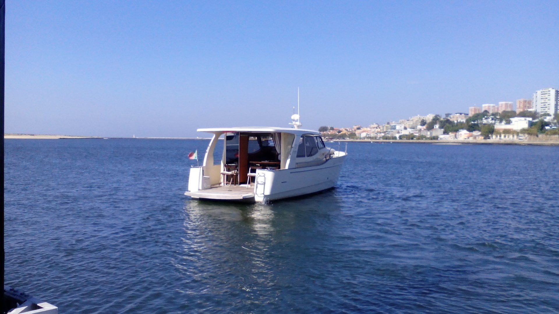 A boat is floating on top of a body of water