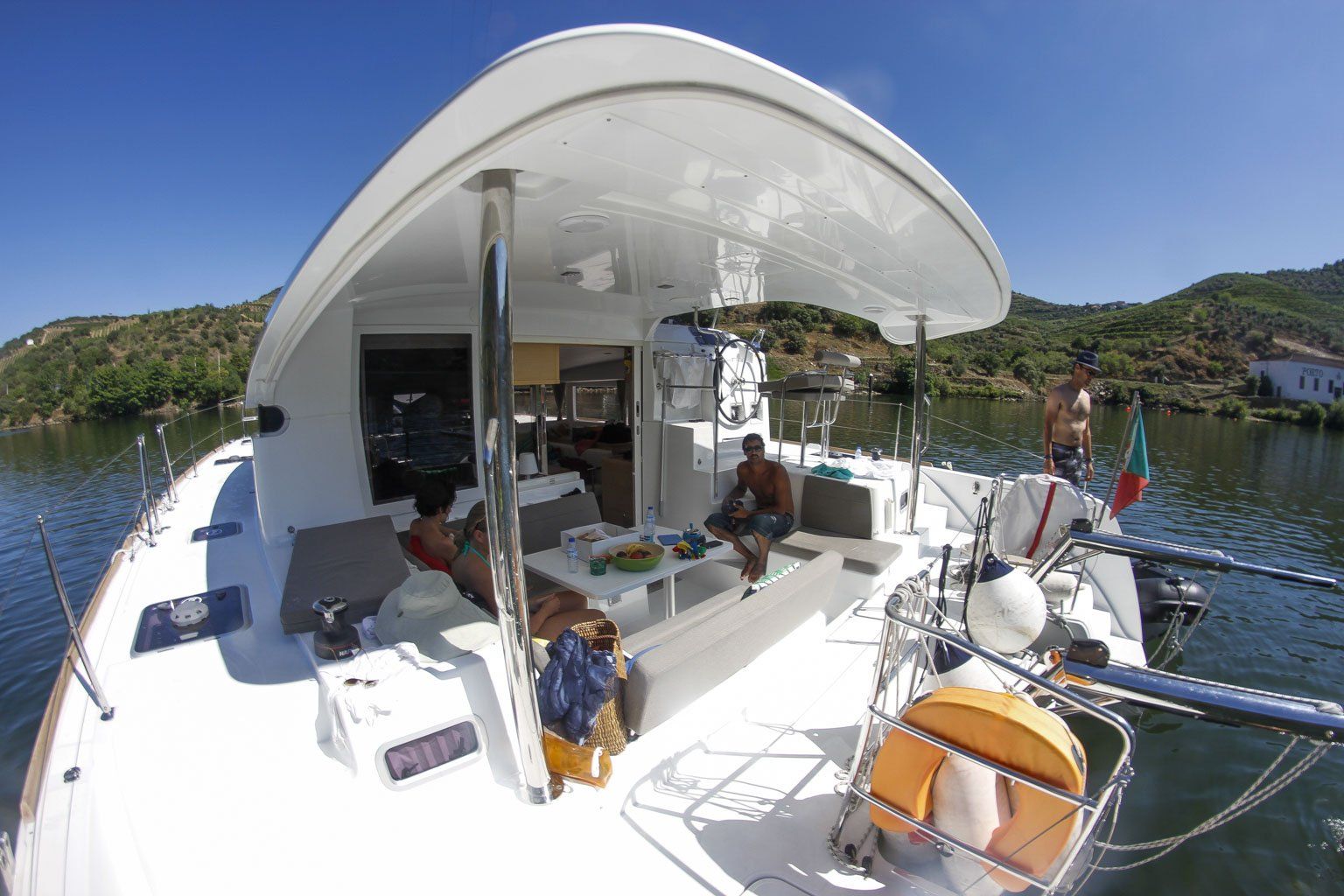 A white boat is floating on top of a body of water.