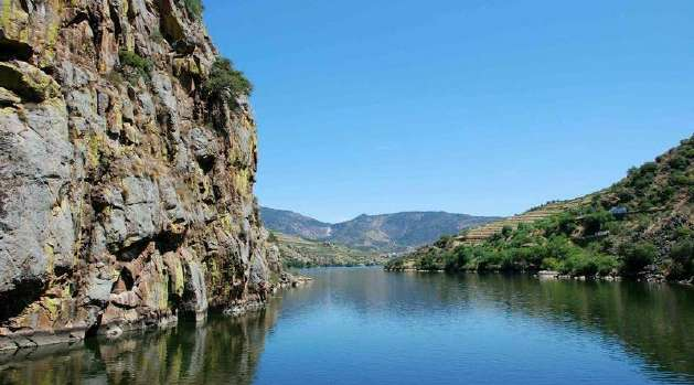 A large body of water surrounded by rocks and mountains.