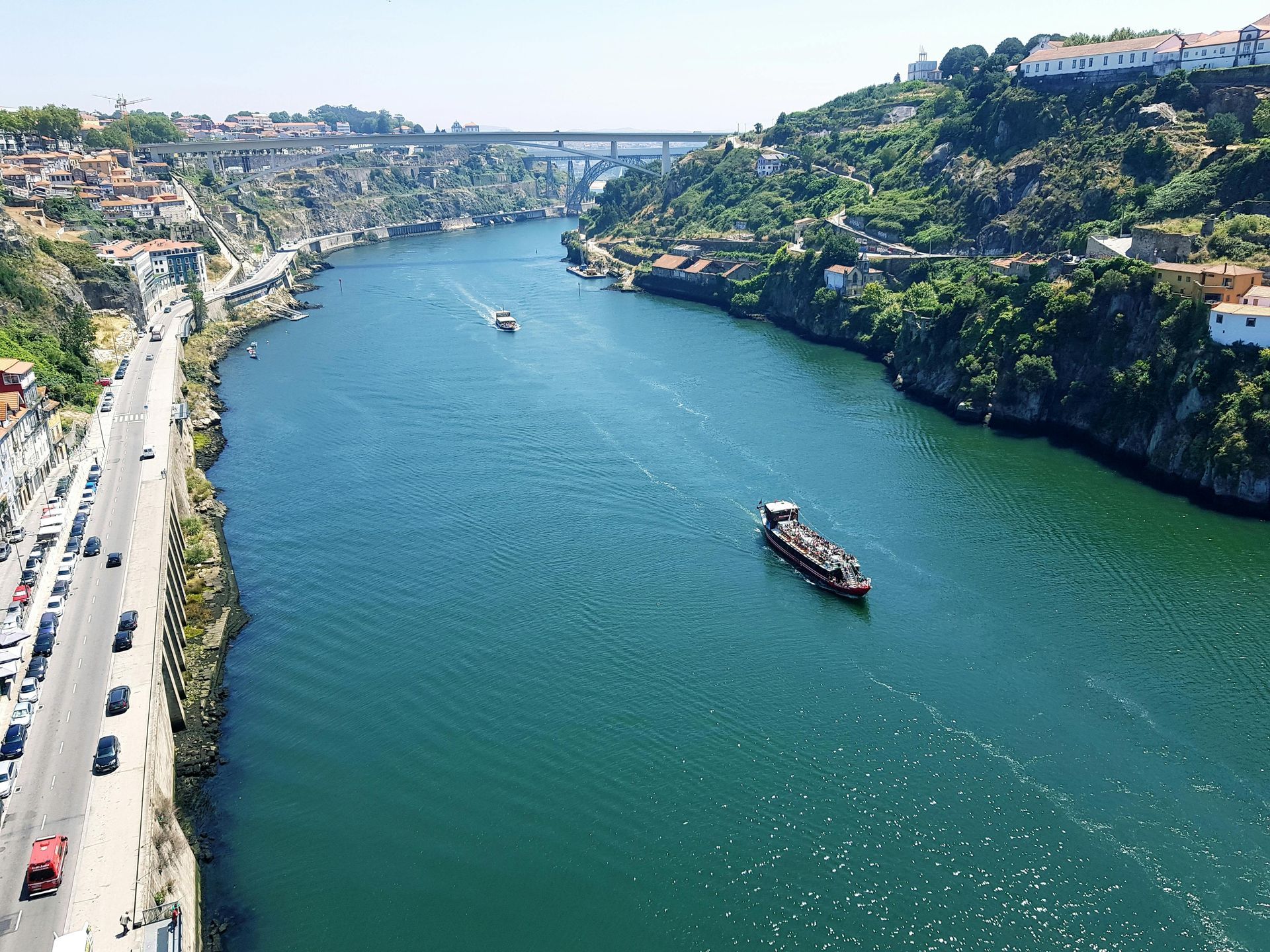 An aerial view of a river with a boat in the middle of it.