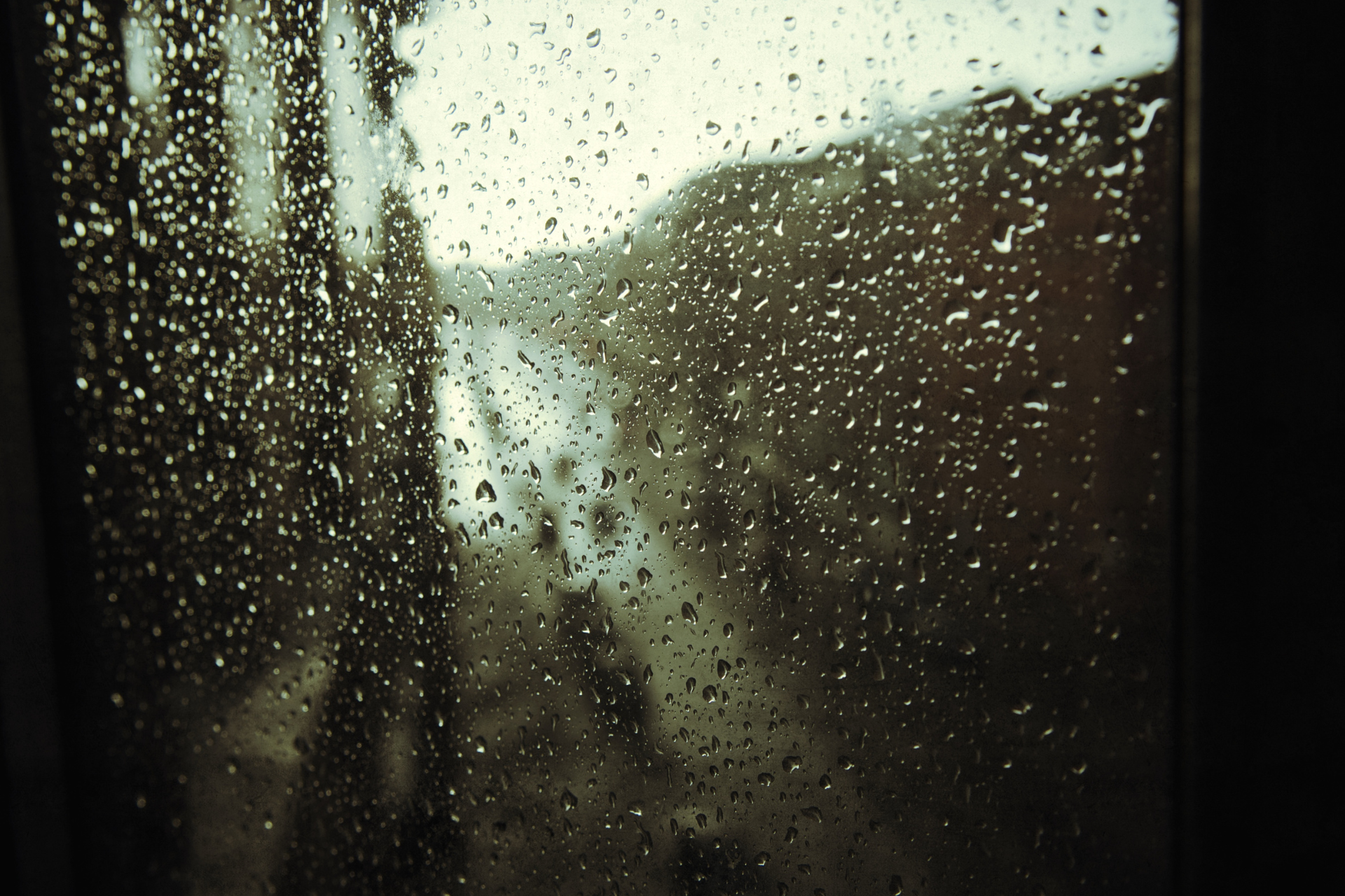 A window with a lot of rain drops on it