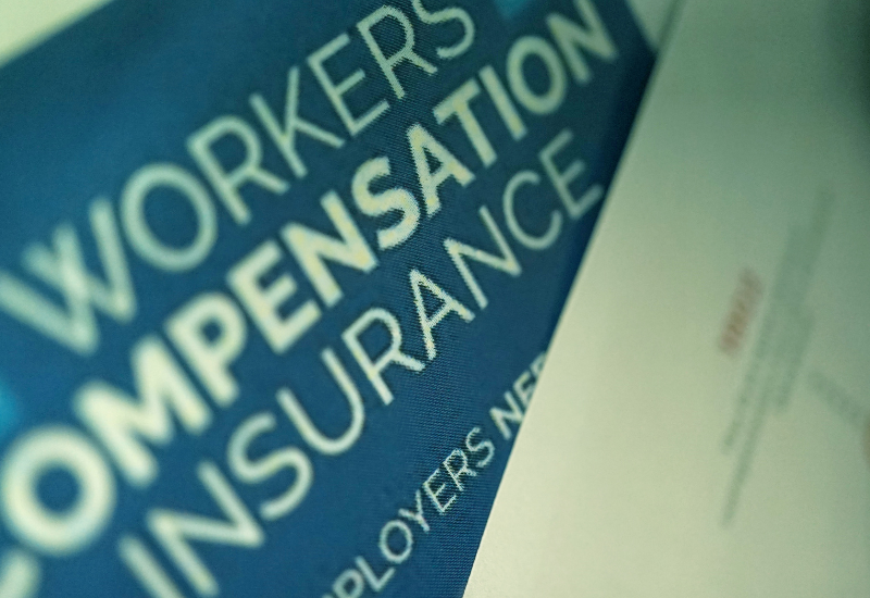 A blue sign that says workers compensation insurance