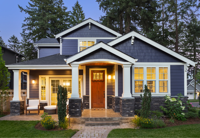 A blue house with white trim and a brown door