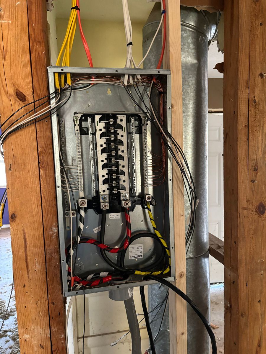 A electrical box is hanging on a wooden wall.