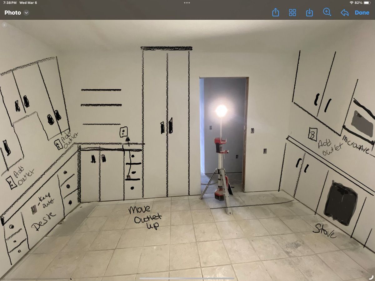 A black and white drawing of a kitchen with the words 