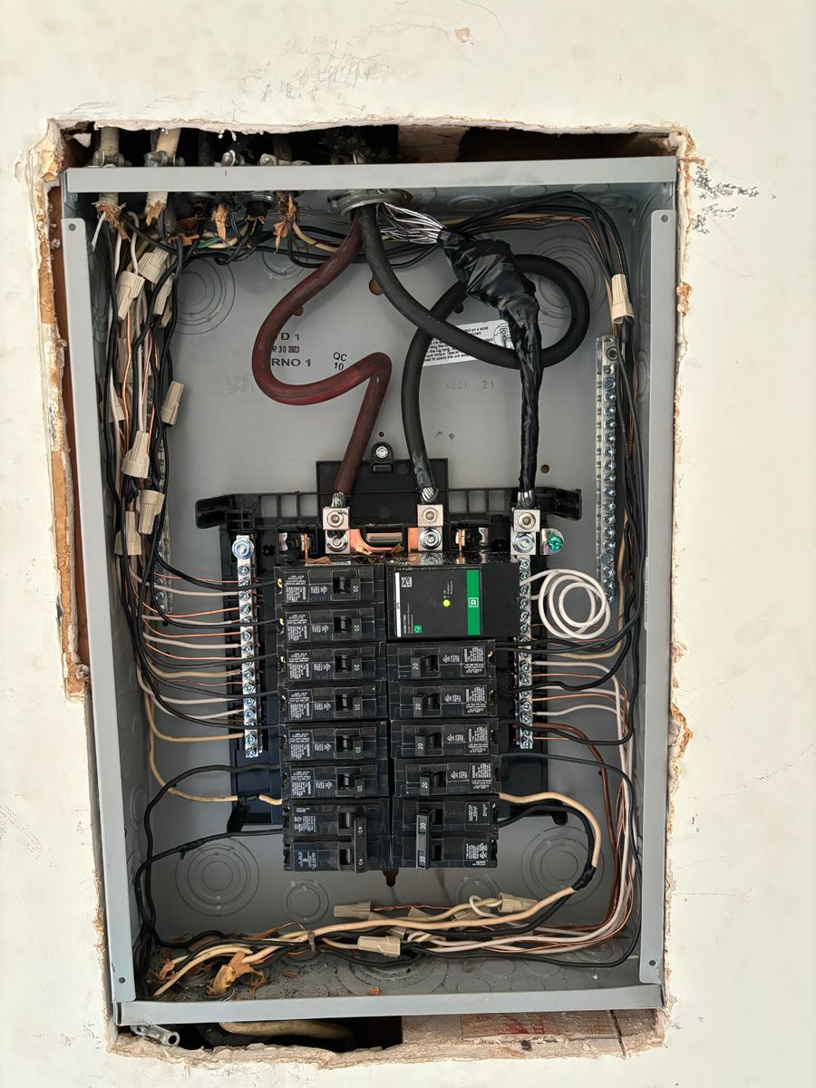 An electrical box with a lot of wires coming out of it.