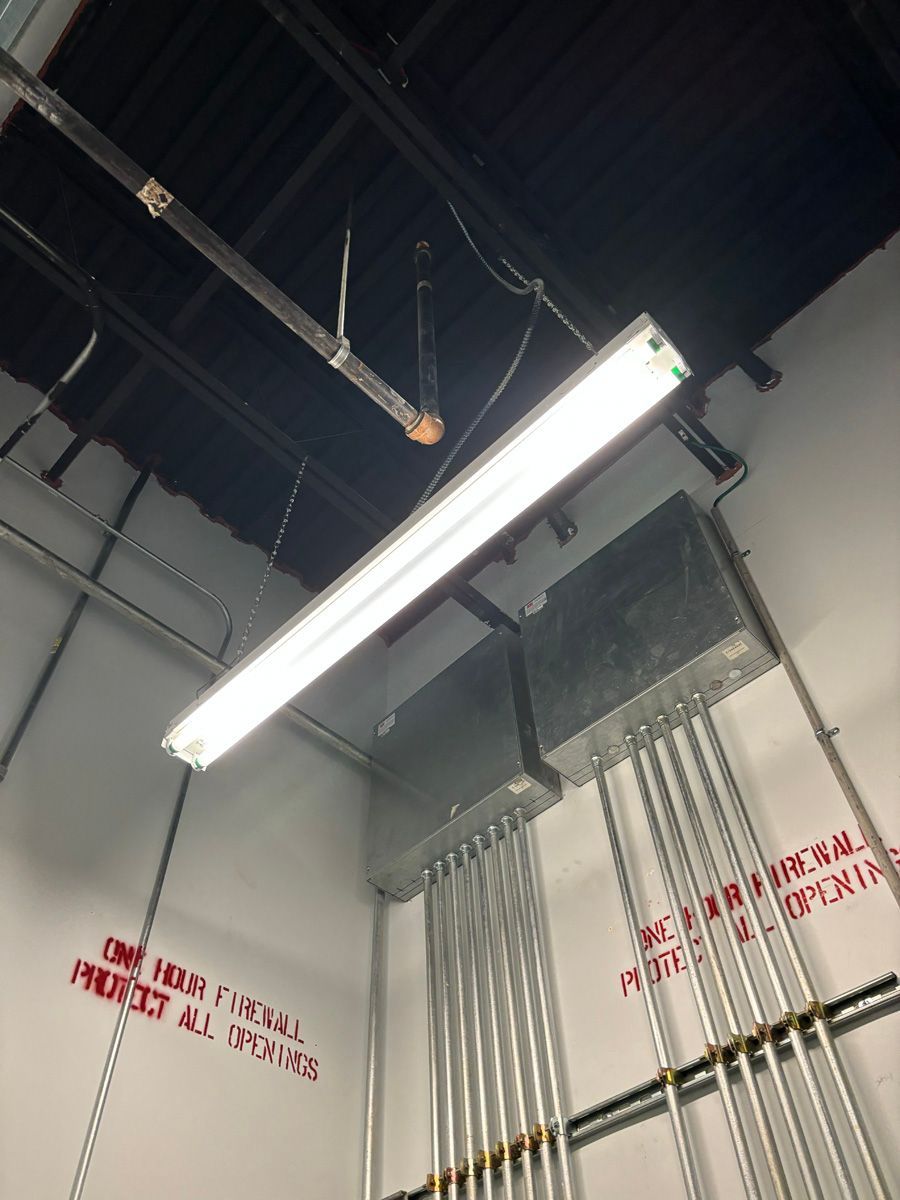 A light fixture is hanging from the ceiling of a building