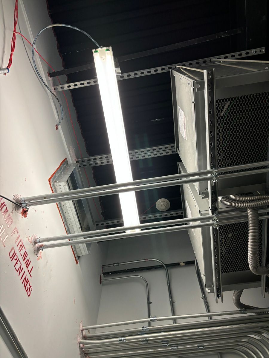 A light is hanging from the ceiling of a building.