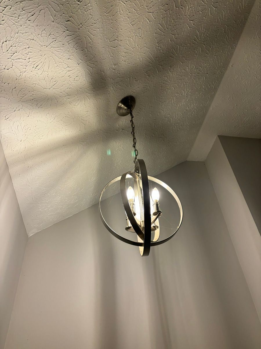 A chandelier is hanging from the ceiling in a room.