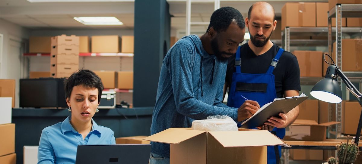 Three small business owners managing orders in a busy office