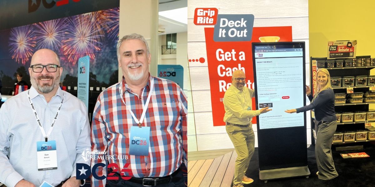Two men standing in front of International Roofing Expo sign smiling