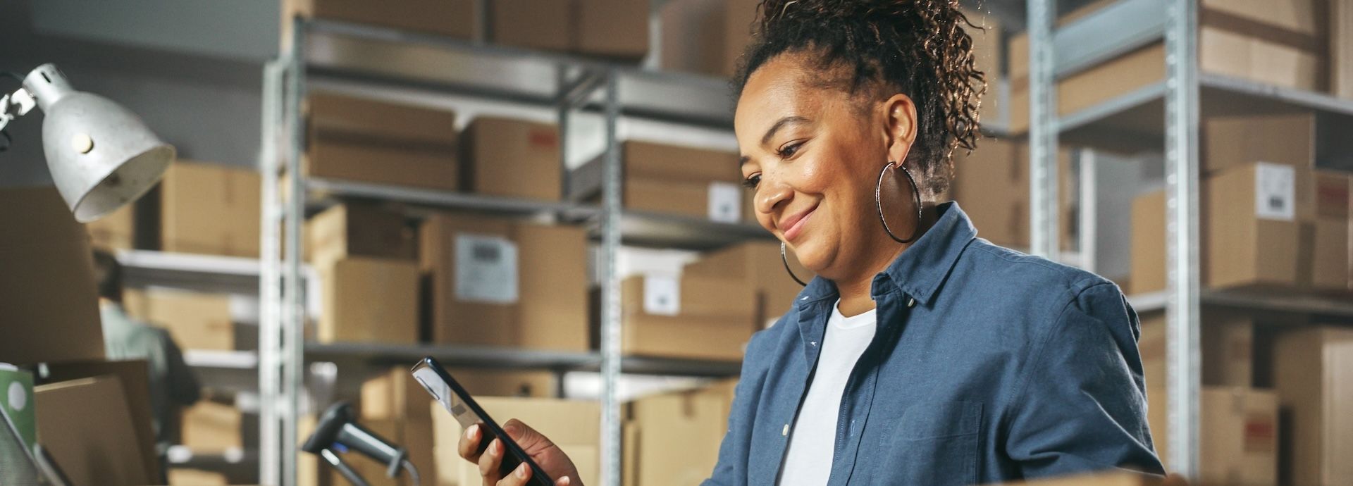 Warehouse worker checking her smartphone