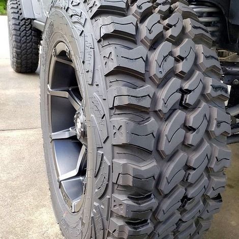 A close up of a tire on a jeep.
