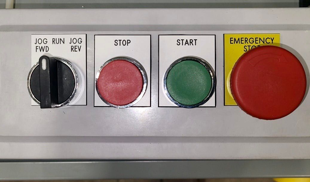 a close up of a control panel with buttons for start stop and emergency stop