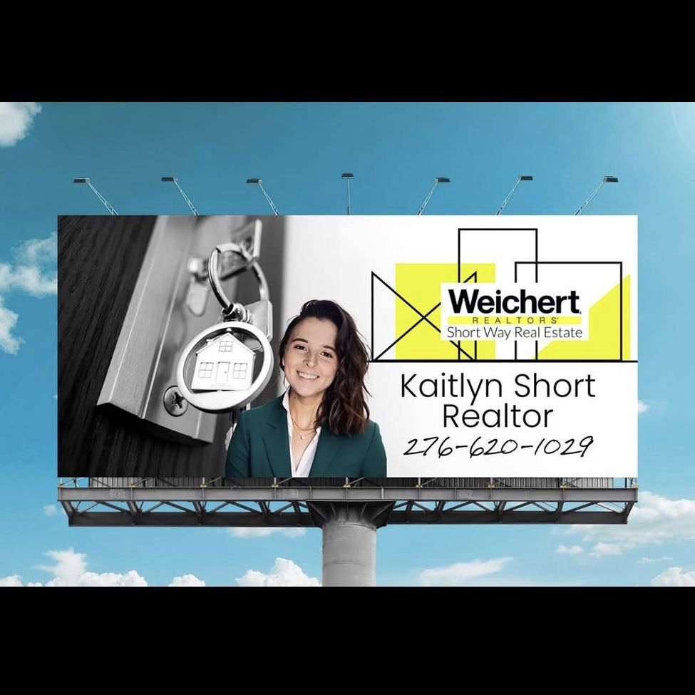 A kitchen with white cabinets and a large island in the middle.