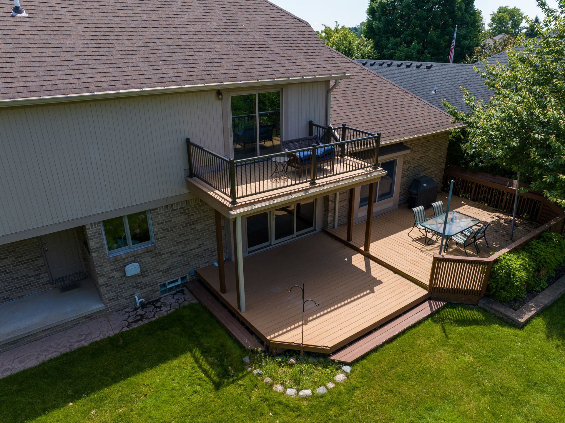 An aerial view of a house with a large deck.