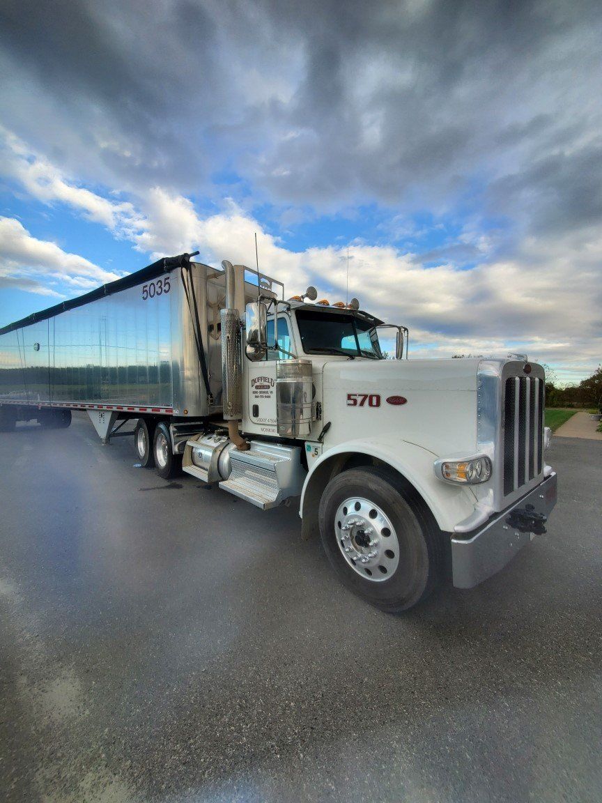 Mechanic Fixing A Tractor — King George, VA — Duffield Hauling Inc.