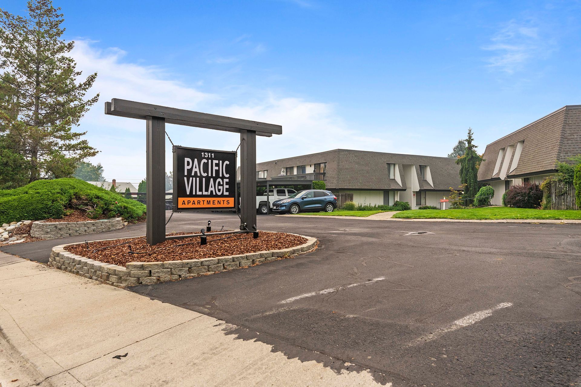 A parking lot with a sign that says pacific village