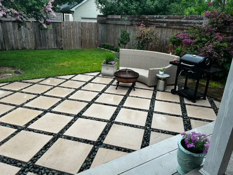 A patio with a fire pit and a grill