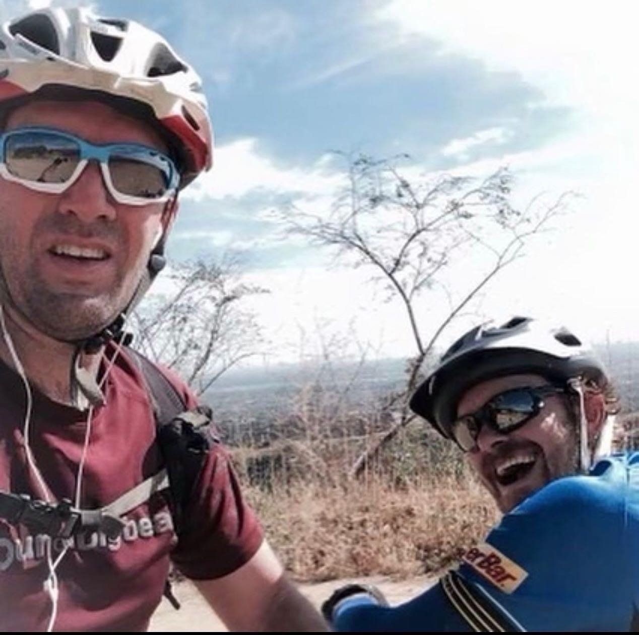 Adam and Matt Bullard smiling while on their bike