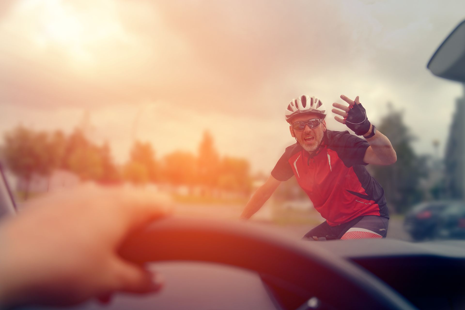 Motorist in the path of a cyclist causing bicycle rider to gesture in anger