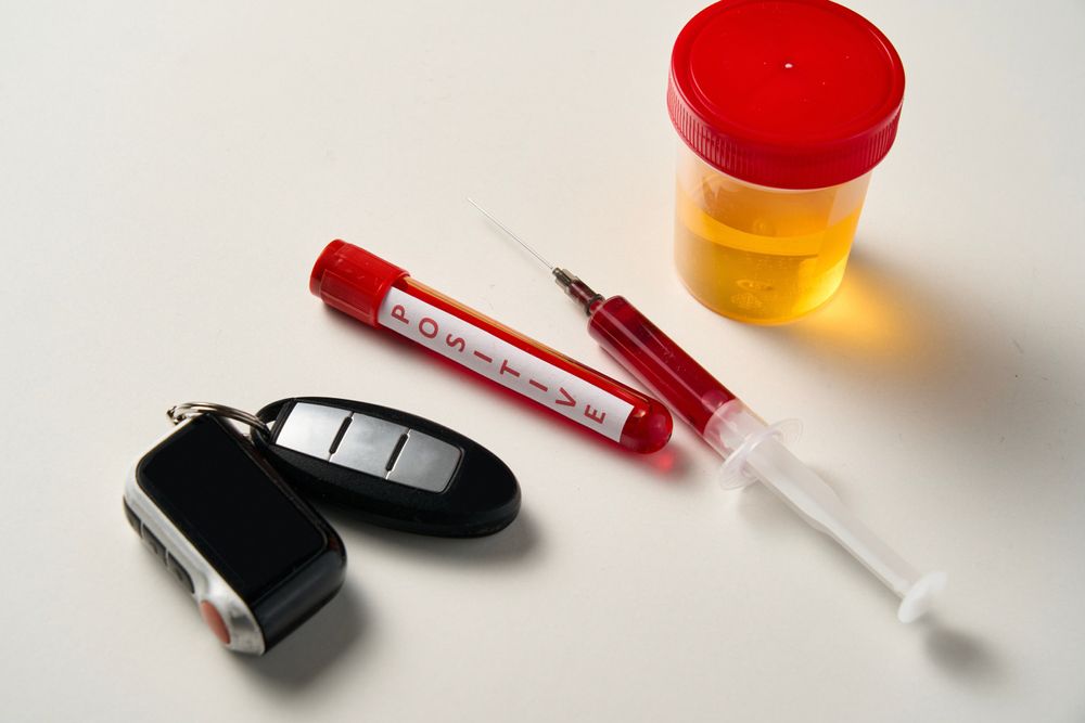 Car keys, urine collection, a vial of blood, and a syringe. The driver undergoes a drug and alcohol test, and a medical examination is conducted to check for the presence of prohibited substances in their blood and urine
