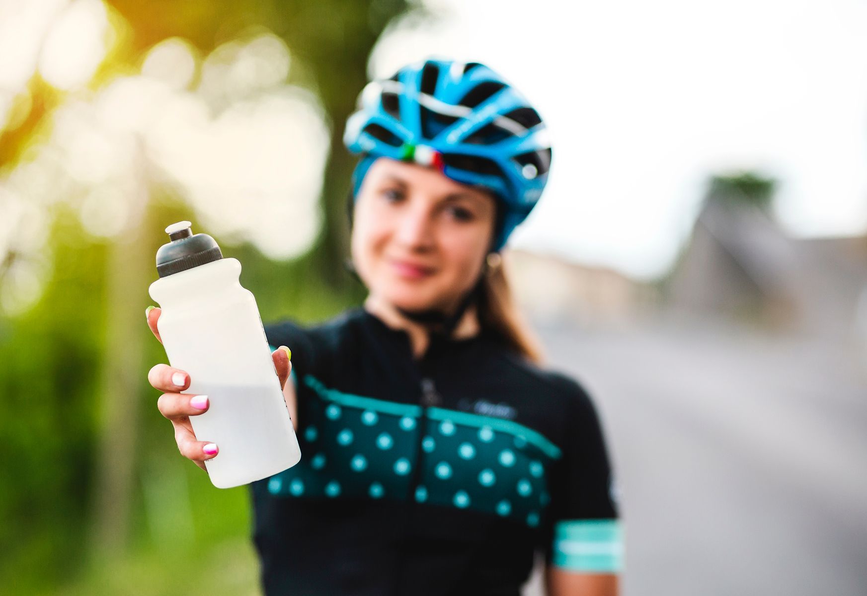 Female cyclist holding water bottle