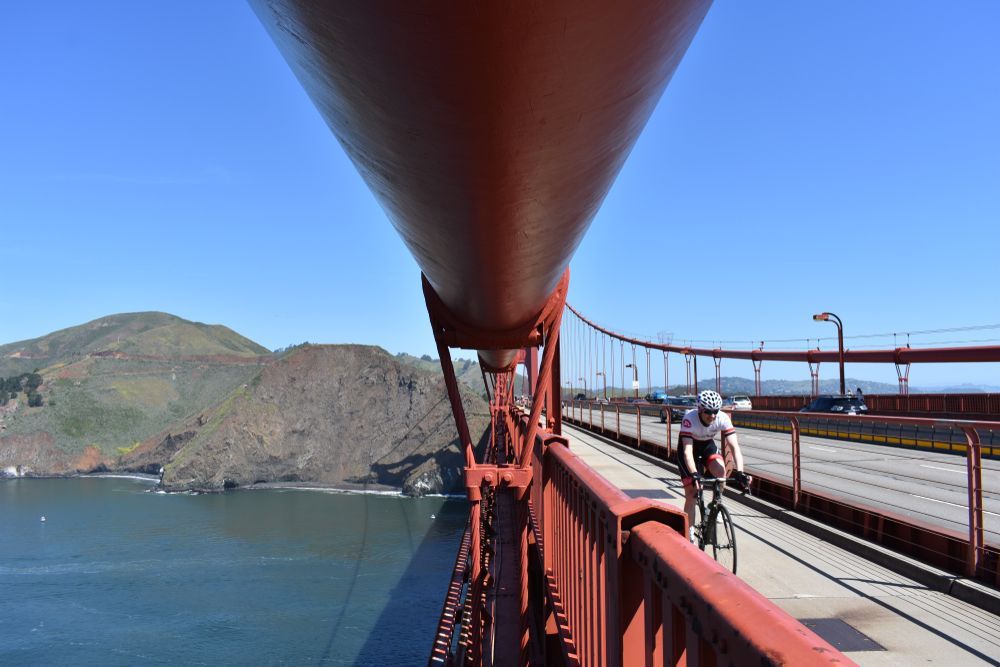 cyclist riding across the Golden Gate Bridge San Francisco, CA