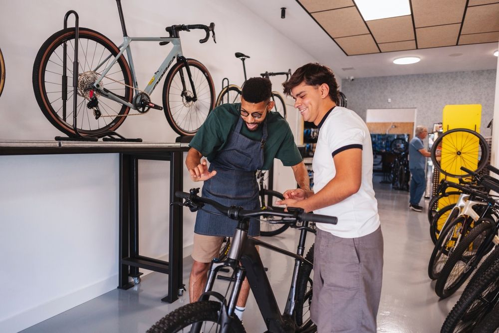 A man is in a bike shop purchasing an electric bicycle