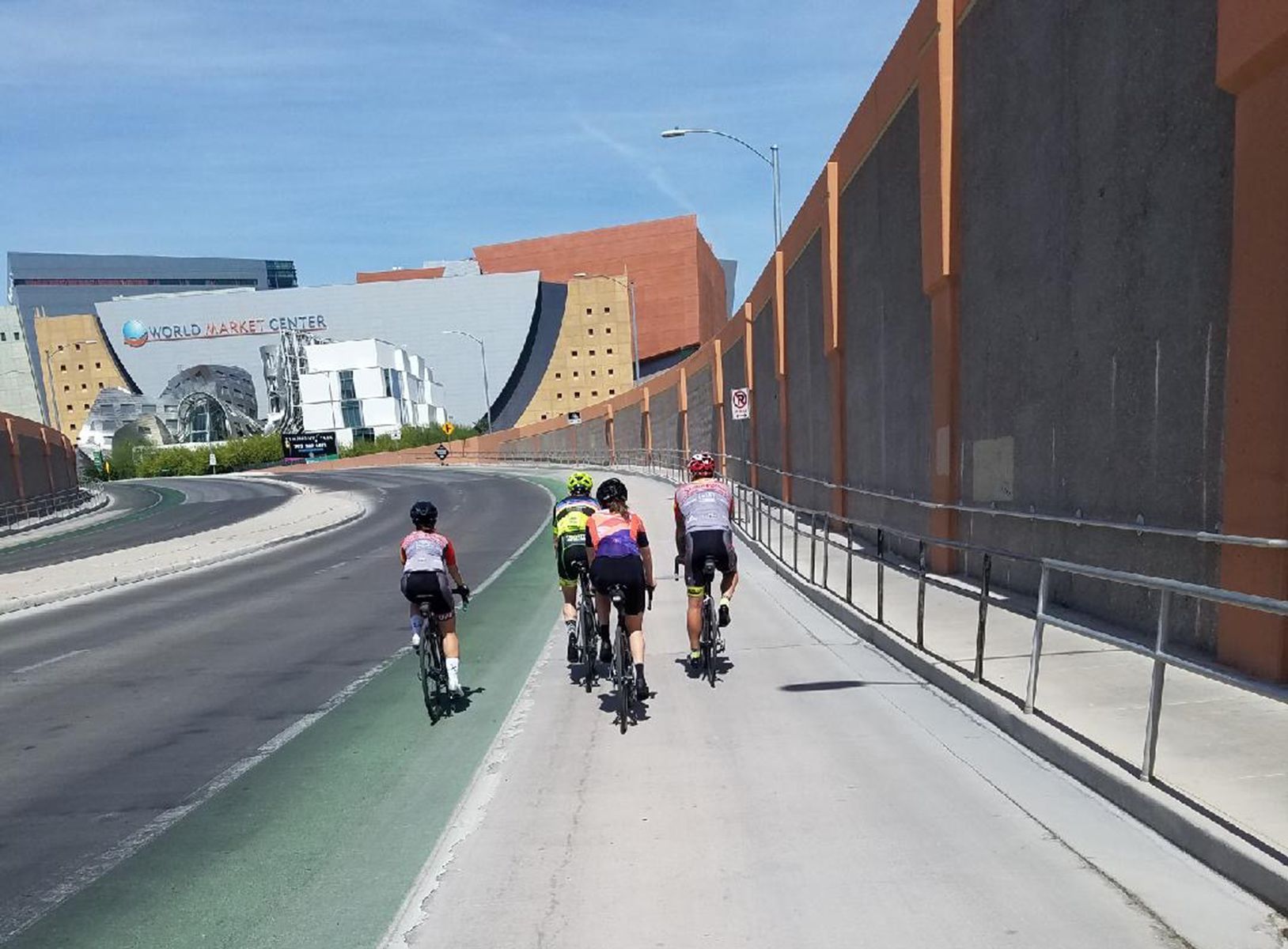a group of cyclists riding on the road near the World Market in Las Vegas