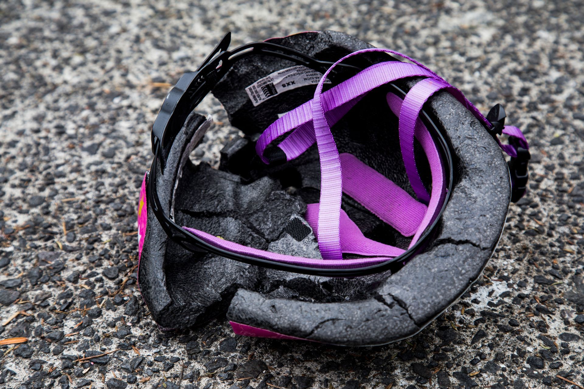 bicycle helmet that is cracked and destroyed from impact