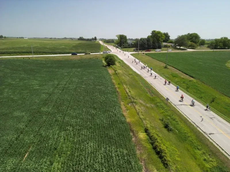Aerial view of long Iowa highway filled with RAGBRAI cyclists