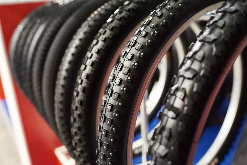 assortment of winter bicycle tires with various tread design and studded vs non studded