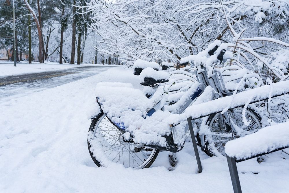 bicycles parked covered in snow winter cycling