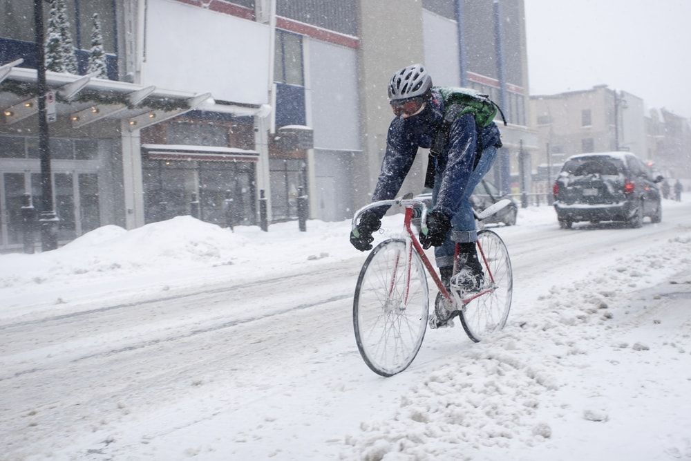 cyclist on road bike on a snowy road