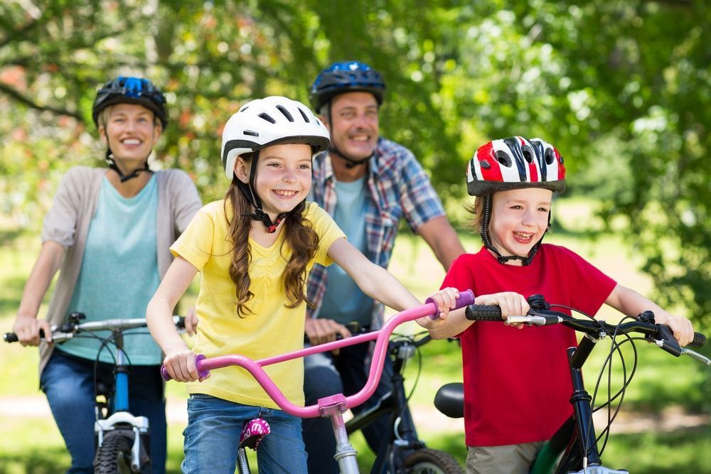 family of four riding e-bikes in San Diego