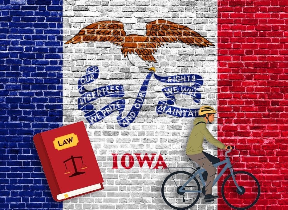 Iowa Bicycle Laws. Illustration of the Iowa flag against a brick wall with a bicycle rider and a law