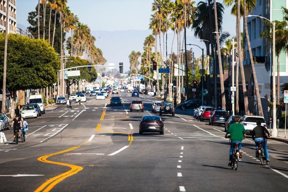 Los Angeles busy street with cars and bicycles lacking dedicated bicycle lanes