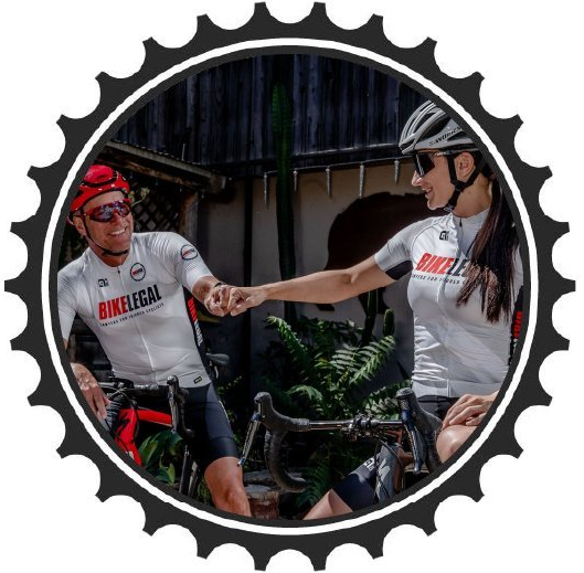 Two Cyclist riding a bike and doing fist bump