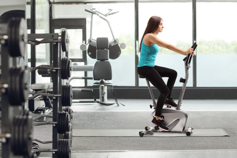 stationary bike at a gym with woman cycling