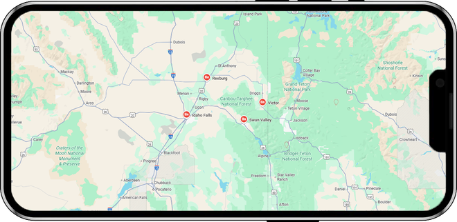 A smartphone displays a map with several points marked, possibly indicating locations in a mountainous region.