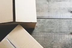 Two cardboard boxes on a wooden table