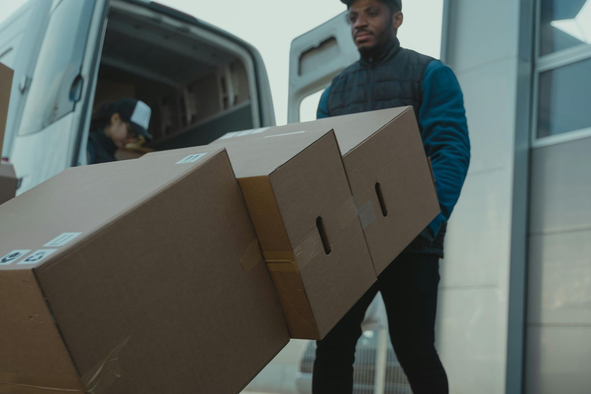 a professional mover operating a dolly with boxes