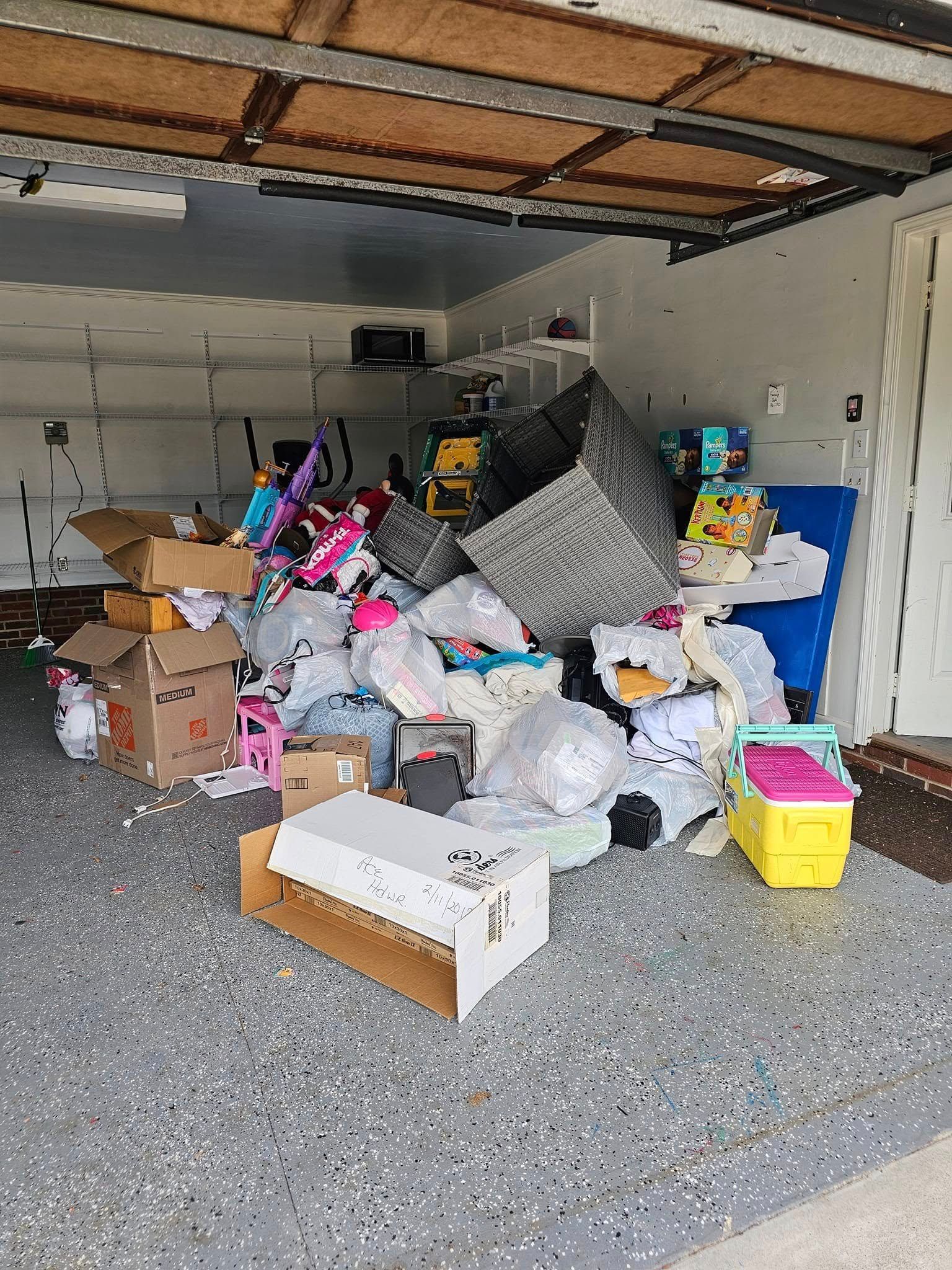 Garage filled with various items including boxes, toys, and plastic bags.