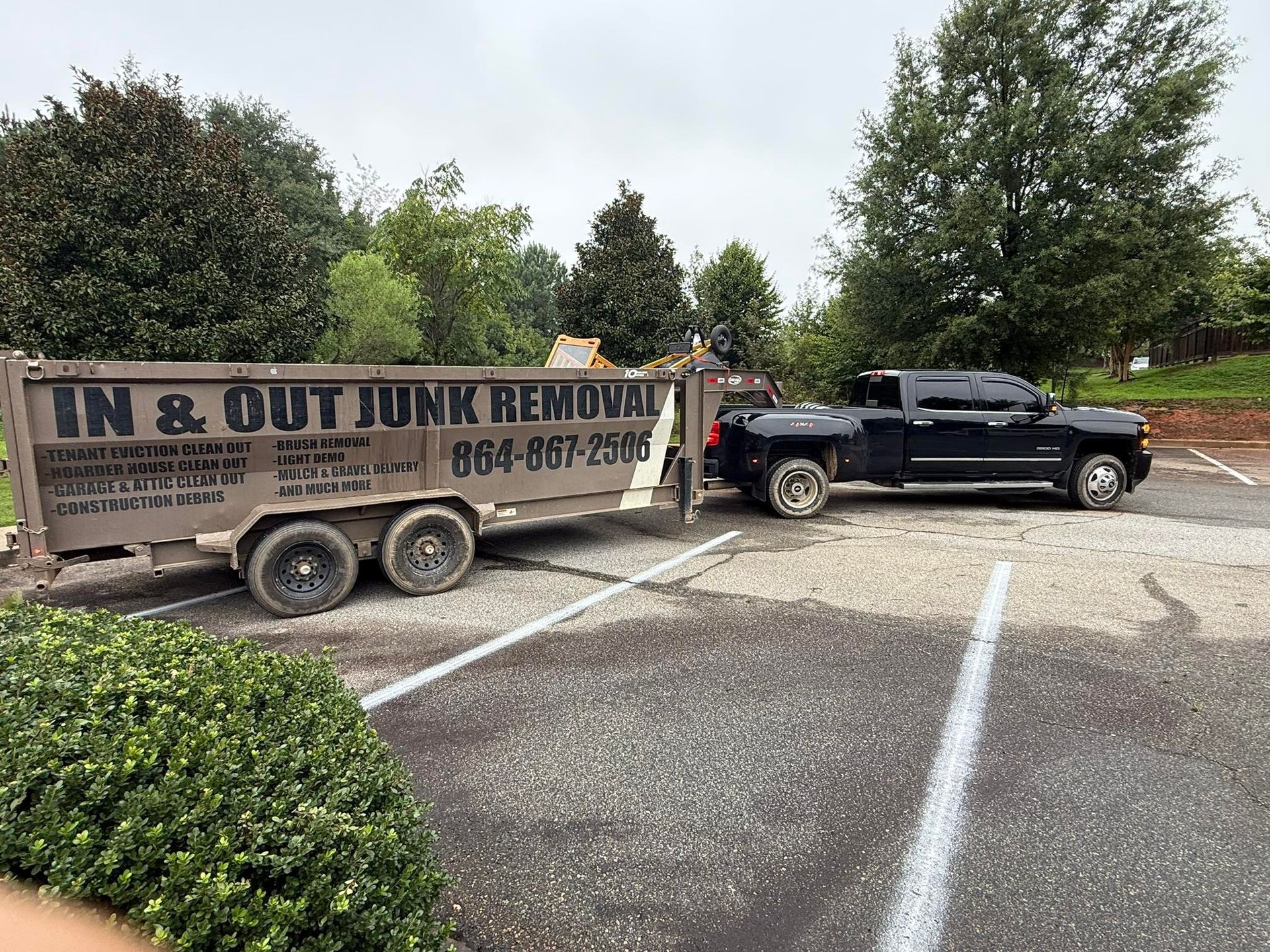 Black truck towing a trailer with 